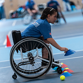 Junior players looking to improve their skills by working on drills with cones and tennis balls.